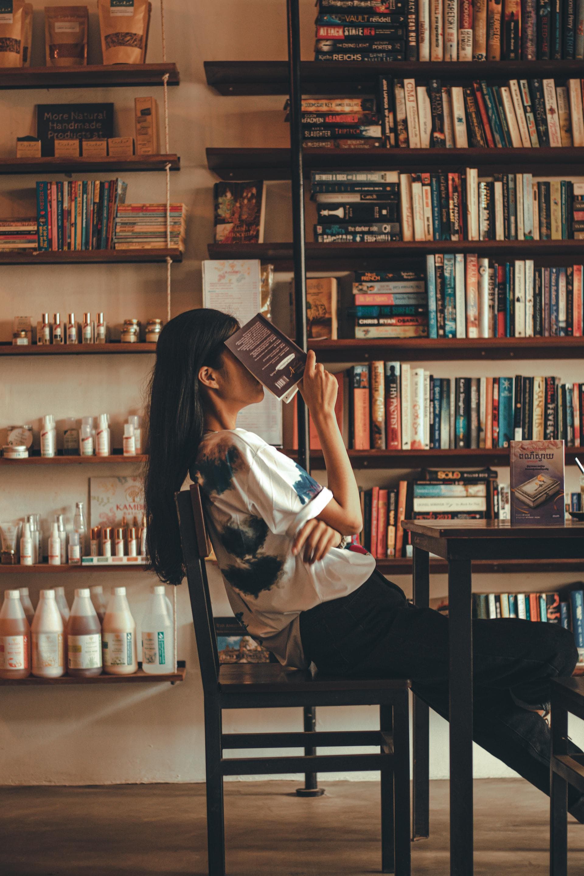 Image of a girl with a book on her face